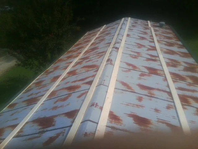 Rusted metal roof panels with new wood purlins before replacement — Storm Damage Roof Repair in Mount Carmel by Roofing Brothers
